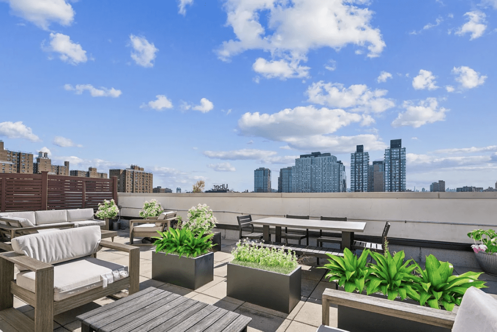 Rooftop lounge featuring modern seating and planters