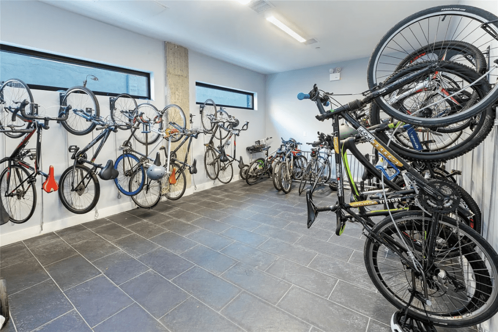 A well-organized bike storage room featuring multiple bicycles hung on the walls