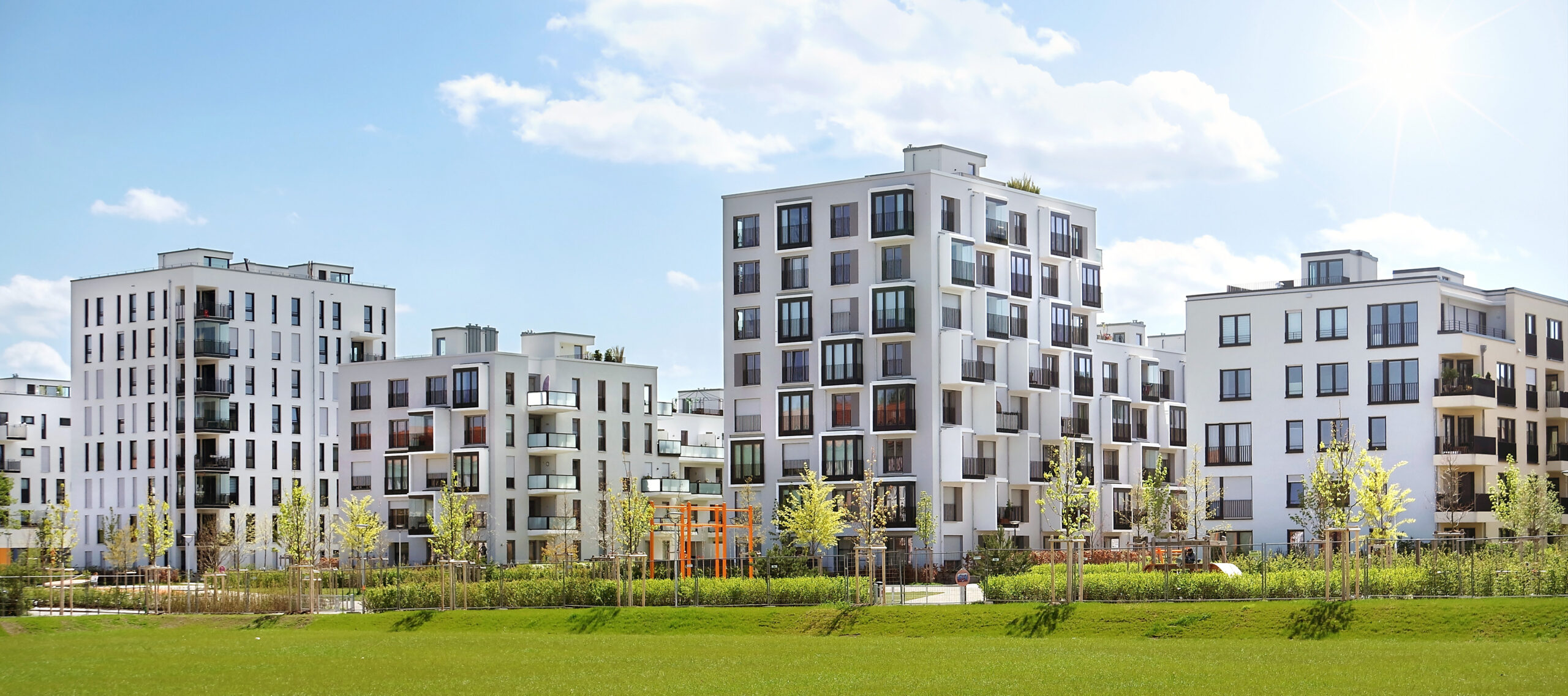 Modern apartment buildings with balconies and landscaped grounds